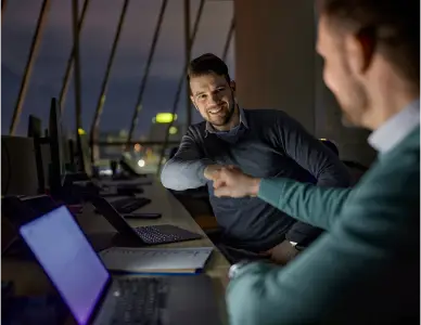 Two men fist bumping about a deal of joint product development