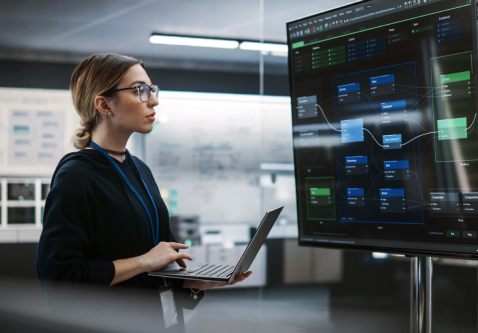 a woman in front of a screen working on a fpga design